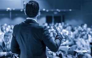 engaging speaker in front of large crowd